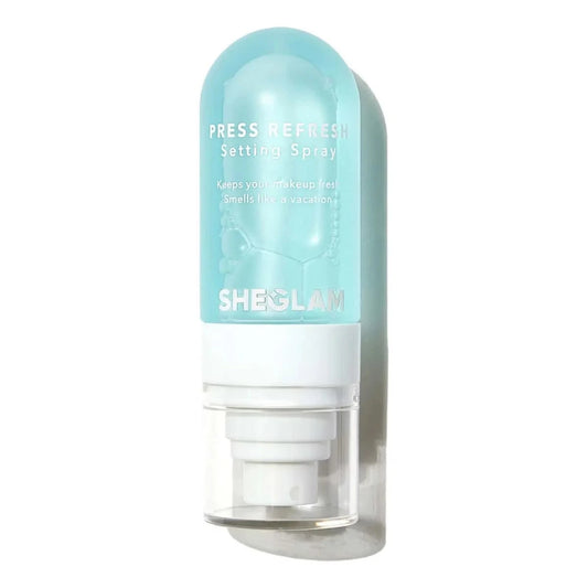 Sheglam Press Refresh Setting Spray in a translucent light blue bottle with a white pump dispenser, shown against a plain white background.